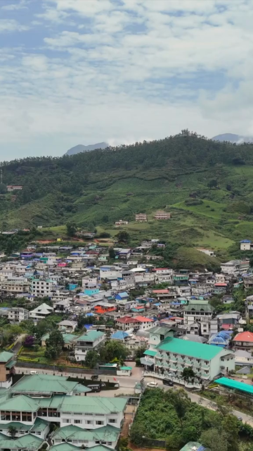 Vertical Aerial View of Mountain Town and Lush Landscape in Kerala India