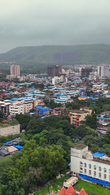 Vertical Aerial View of Pune City with Green Hills and Monsoon Landscape Maharashtra