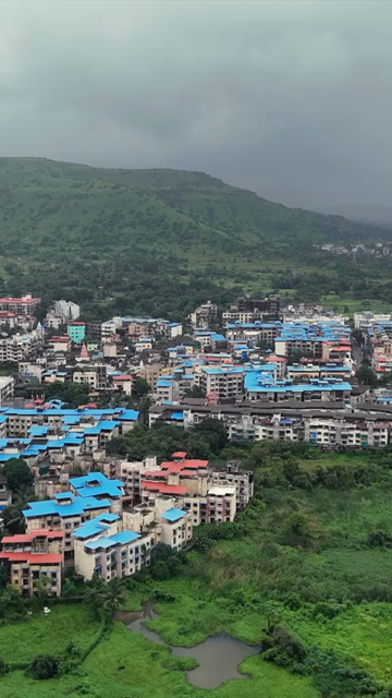 Vertical Aerial View of Pune City with Green Hills and Monsoon Landscape Maharashtra