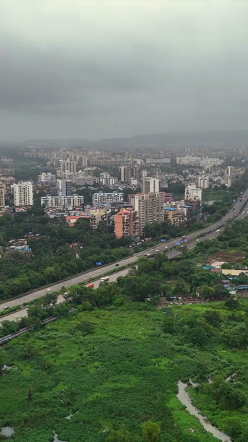 Vertical Aerial View of Pune City with Green Hills and Monsoon Landscape Maharashtra