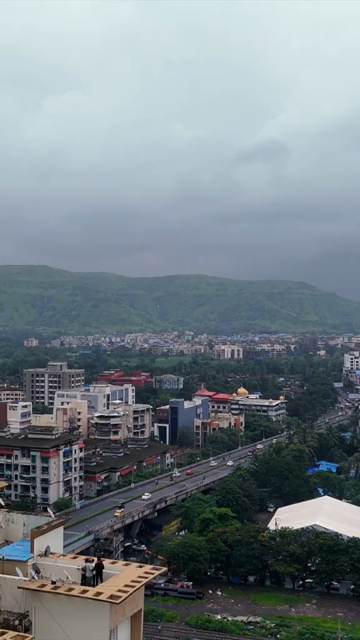 Vertical Aerial View of Pune City with Green Hills and Monsoon Landscape Maharashtra