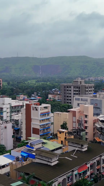 Vertical Aerial View of Pune City with Green Hills and Monsoon Landscape Maharashtra