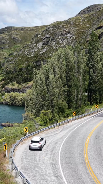 Vertical Aerial View of Scenic Road Along Lake Wanaka in New Zealand