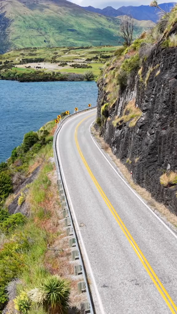 Vertical Aerial View of Scenic Road Along Lake Wanaka in New Zealand