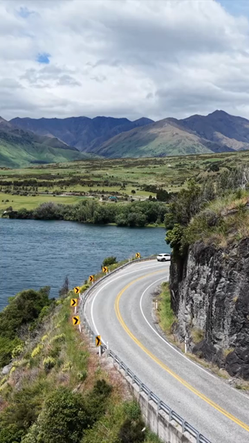 Vertical Aerial View of Scenic Road Along Lake Wanaka in New Zealand