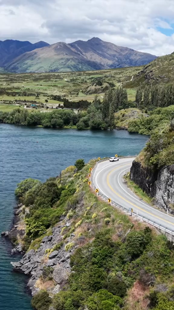 Vertical Aerial View of Scenic Road Along Lake Wanaka in New Zealand