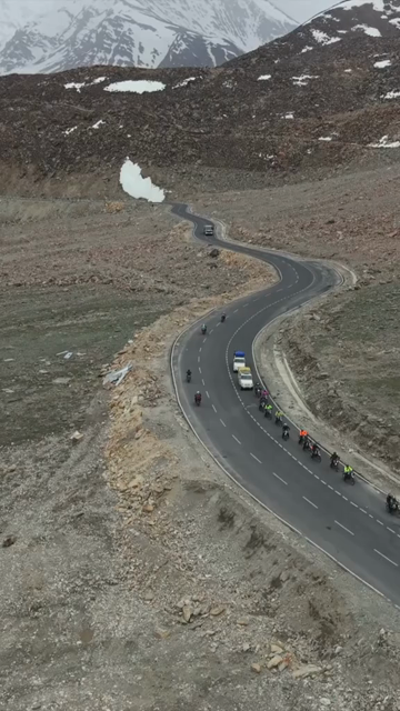 Vertical Aerial View of Tourist Bikers Riding Through Ladakh, India