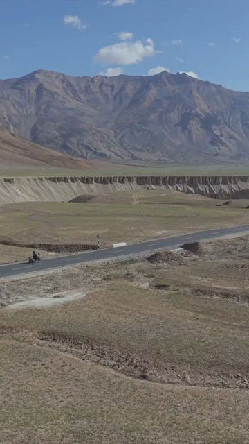 Vertical Aerial View of Tourist Bikers Riding Through Ladakh, India