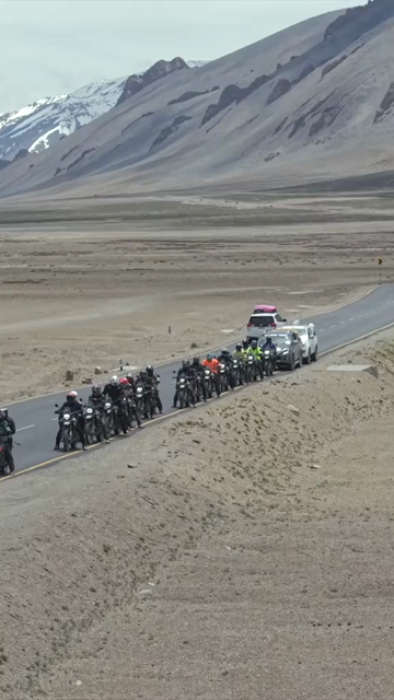 Vertical Aerial View of Tourist Bikers Riding Through Ladakh, India
