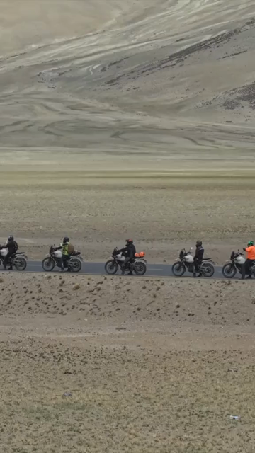 Vertical Aerial View of Tourist Bikers Riding Through Ladakh, India