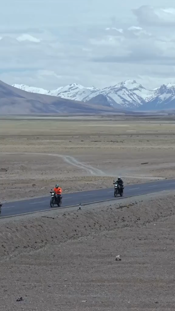 Vertical Aerial View of Tourist Bikers Riding Through Ladakh, India