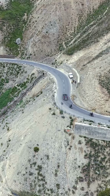 Vertical Aerial View of Tourist Bikers Riding Through Ladakh, India