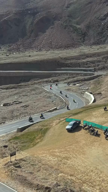 Vertical Aerial View of Tourist Bikers Riding Through Ladakh, India
