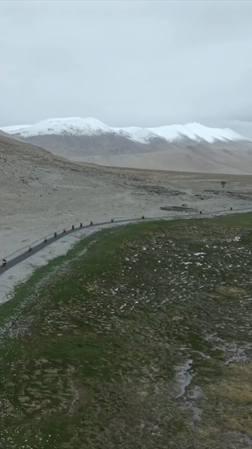 Vertical Aerial View of Tourist Bikers Riding Through Ladakh, India