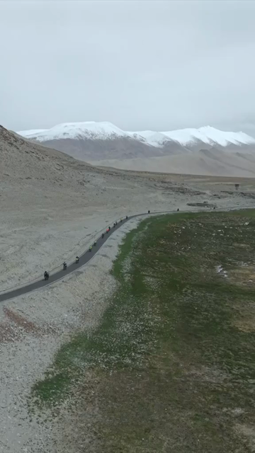 Vertical Aerial View of Tourist Bikers Riding Through Ladakh, India