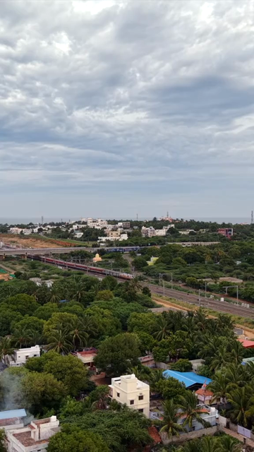 Vertical Aerial View of Train and Coastal Landscape with Mountains in Kanyakumari Tamil Nadu