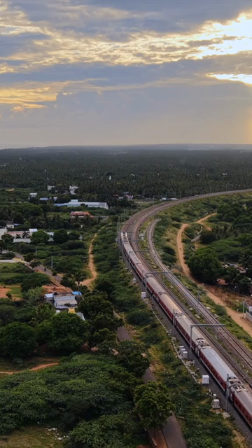Vertical Aerial View of Train and Coastal Landscape with Mountains in Kanyakumari Tamil Nadu