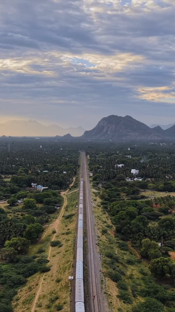 Vertical Aerial View of Train and Coastal Landscape with Mountains in Kanyakumari Tamil Nadu
