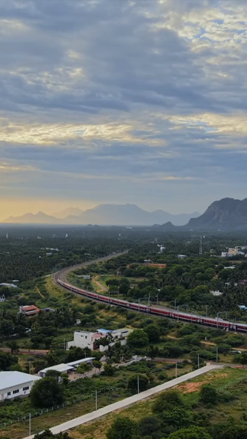 Vertical Aerial View of Train and Coastal Landscape with Mountains in Kanyakumari Tamil Nadu