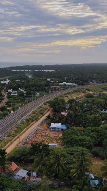 Vertical Aerial View of Train and Coastal Landscape with Mountains in Kanyakumari Tamil Nadu