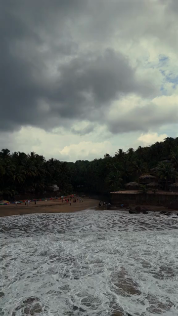 Vertical Aerial View of Tropical Beach and Rocky Coastline in Goa India