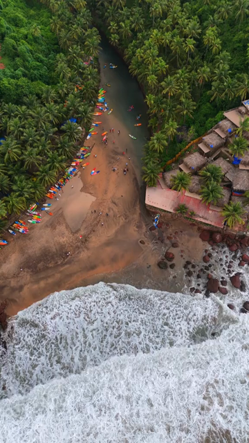 Vertical Aerial View of Tropical Beach and Rocky Coastline in Goa India