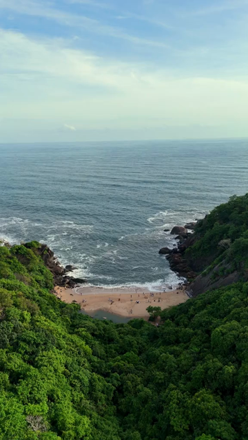 Vertical Aerial View of Tropical Beach and Rocky Coastline in Goa India