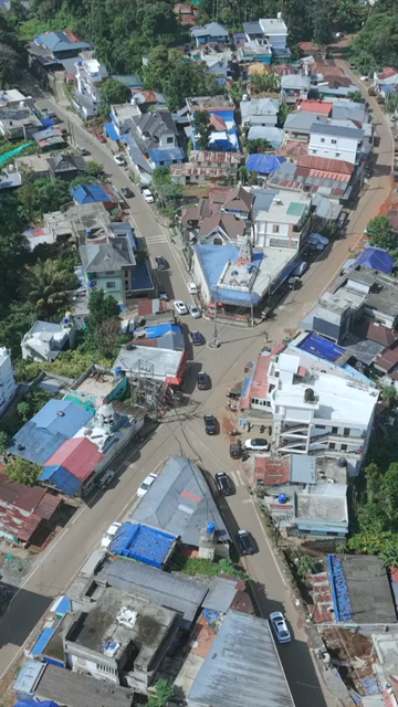 Vertical Aerial View of Tropical Town and Dense Forest in Kerala India