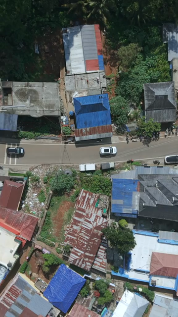 Vertical Aerial View of Tropical Town and Dense Forest in Kerala India