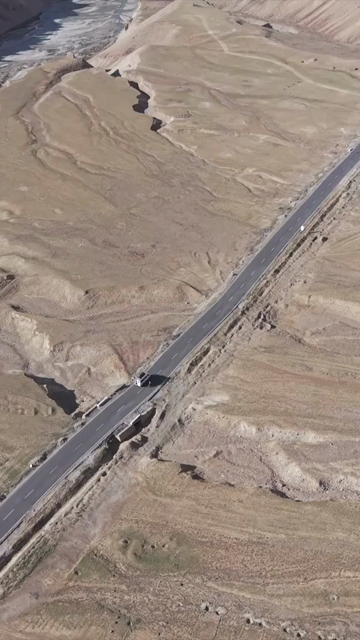 Vertical Aerial View of Vehicle on Mountain Road in Ladakh, India