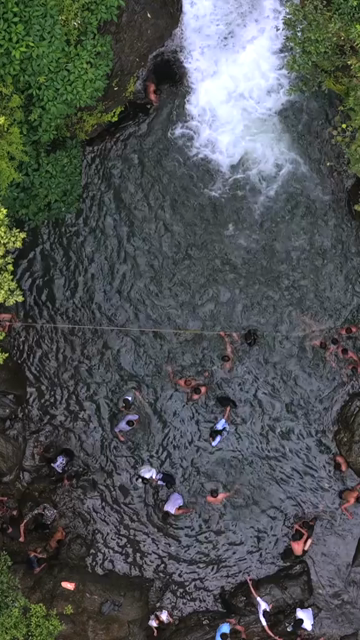Vertical Aerial View of Vibhuti Waterfall Pool with People Bathing Karnataka