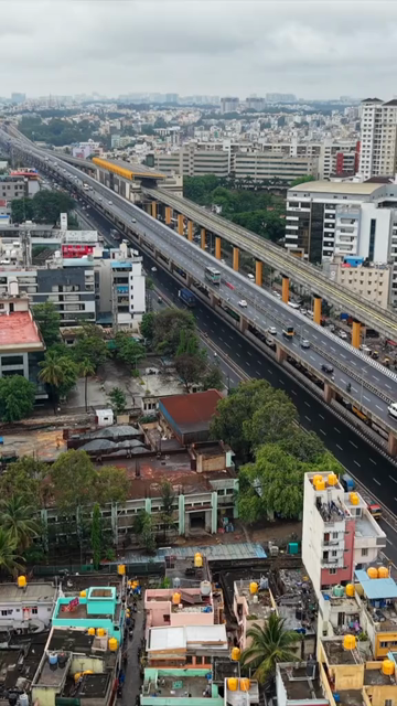 Vertical Aerial View of Waterlogged Road and Metro Corridor After Heavy Rain in Bengaluru India