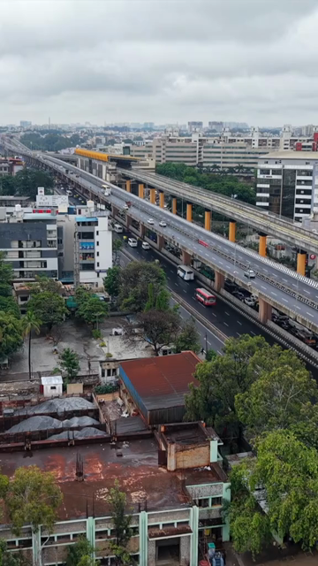 Vertical Aerial View of Waterlogged Road and Metro Corridor After Heavy Rain in Bengaluru India