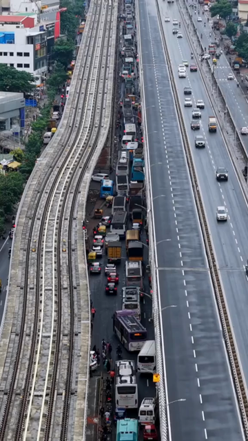 Vertical Aerial View of Waterlogged Road and Metro Corridor After Heavy Rain in Bengaluru India