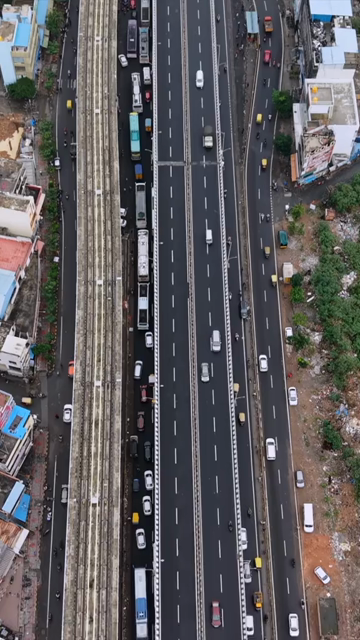 Vertical Aerial View of Waterlogged Road and Metro Corridor After Heavy Rain in Bengaluru India