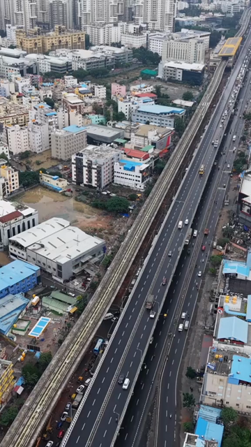 Vertical Aerial View of Waterlogged Road and Metro Corridor After Heavy Rain in Bengaluru India