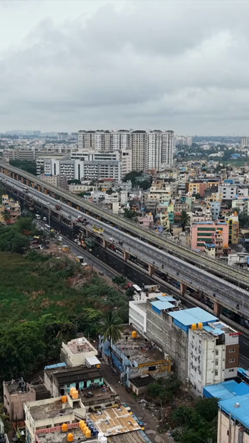 Vertical Aerial View of Waterlogged Road and Metro Corridor After Heavy Rain in Bengaluru India
