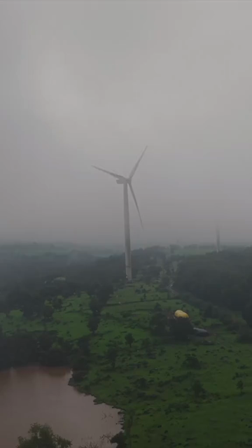 Vertical Aerial View of Wind Turbine in Misty Monsoon Landscape Ratnagiri Maharashtra India