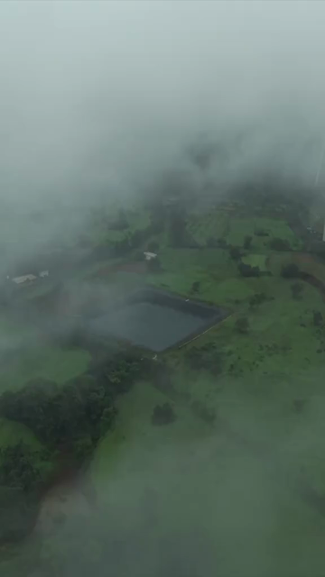 Vertical Aerial View of Wind Turbine in Misty Monsoon Landscape Ratnagiri Maharashtra India