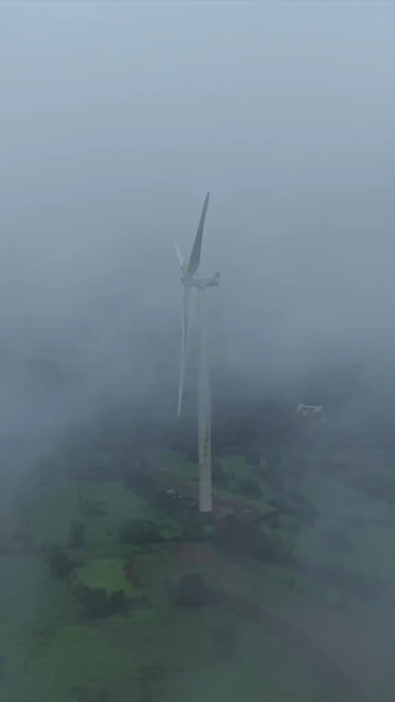 Vertical Aerial View of Wind Turbine in Misty Monsoon Landscape Ratnagiri Maharashtra India