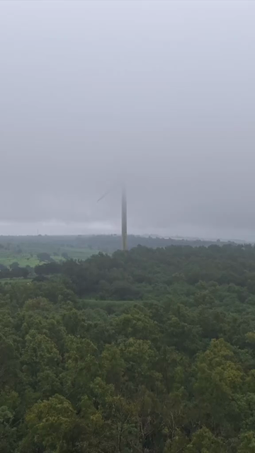 Vertical Aerial View of Wind Turbine in Misty Monsoon Landscape Ratnagiri Maharashtra India