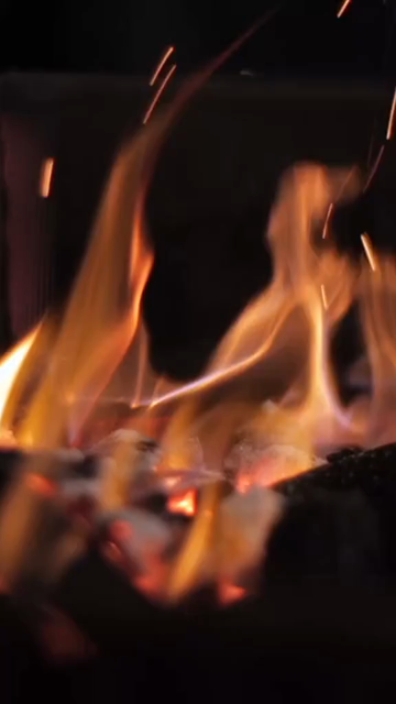 Vertical Close Up of Bonfire Flames and Glowing Embers