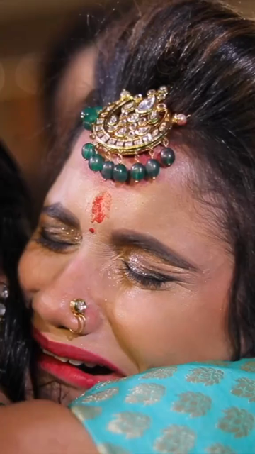 Vertical Close Up of Emotional Bride Hugging Her Mother During Indian Wedding