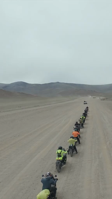 Vertical FPV Drone View of Adventure Motorcyclists Crossing Desert Plains in Ladakh