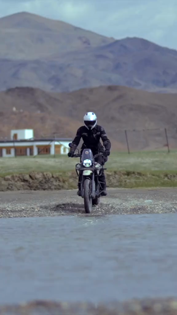 Vertical Shot of Adventure Motorcyclist Crossing River in Ladakh, India