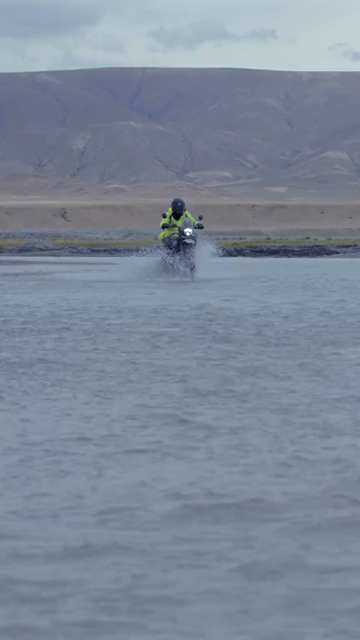 Vertical Shot of Adventure Motorcyclist Crossing River in Ladakh, India