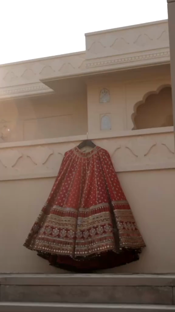 Vertical Shot of Bridal Lehenga Hanging at Wedding Ceremony