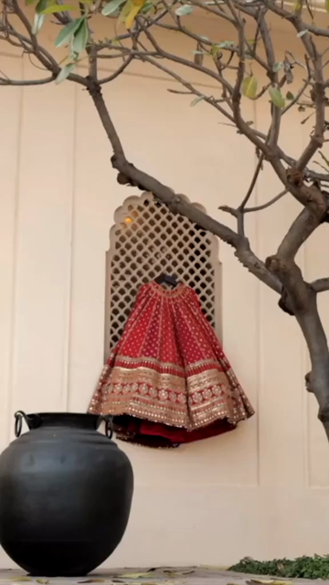 Vertical Shot of Bridal Lehenga Hanging at Wedding Ceremony