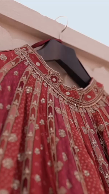 Vertical Shot of Bridal Lehenga Hanging at Wedding Ceremony