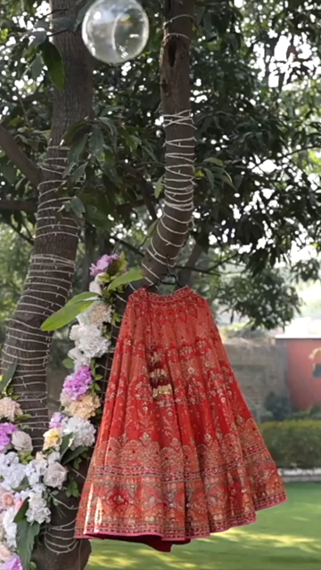 Vertical Shot of Bridal Lehenga Hanging at Wedding Ceremony